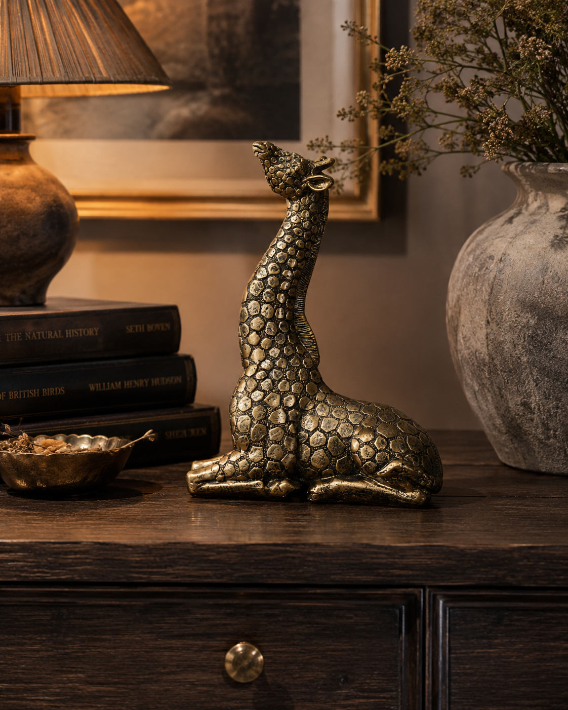 Gold giraffe ornament bringing playful animal character to a styled room.