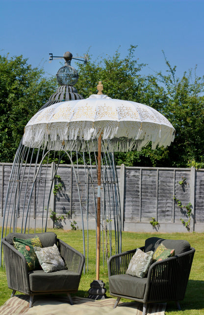 Balinese-style gold and white parasol lifestyle image for luxury garden styling