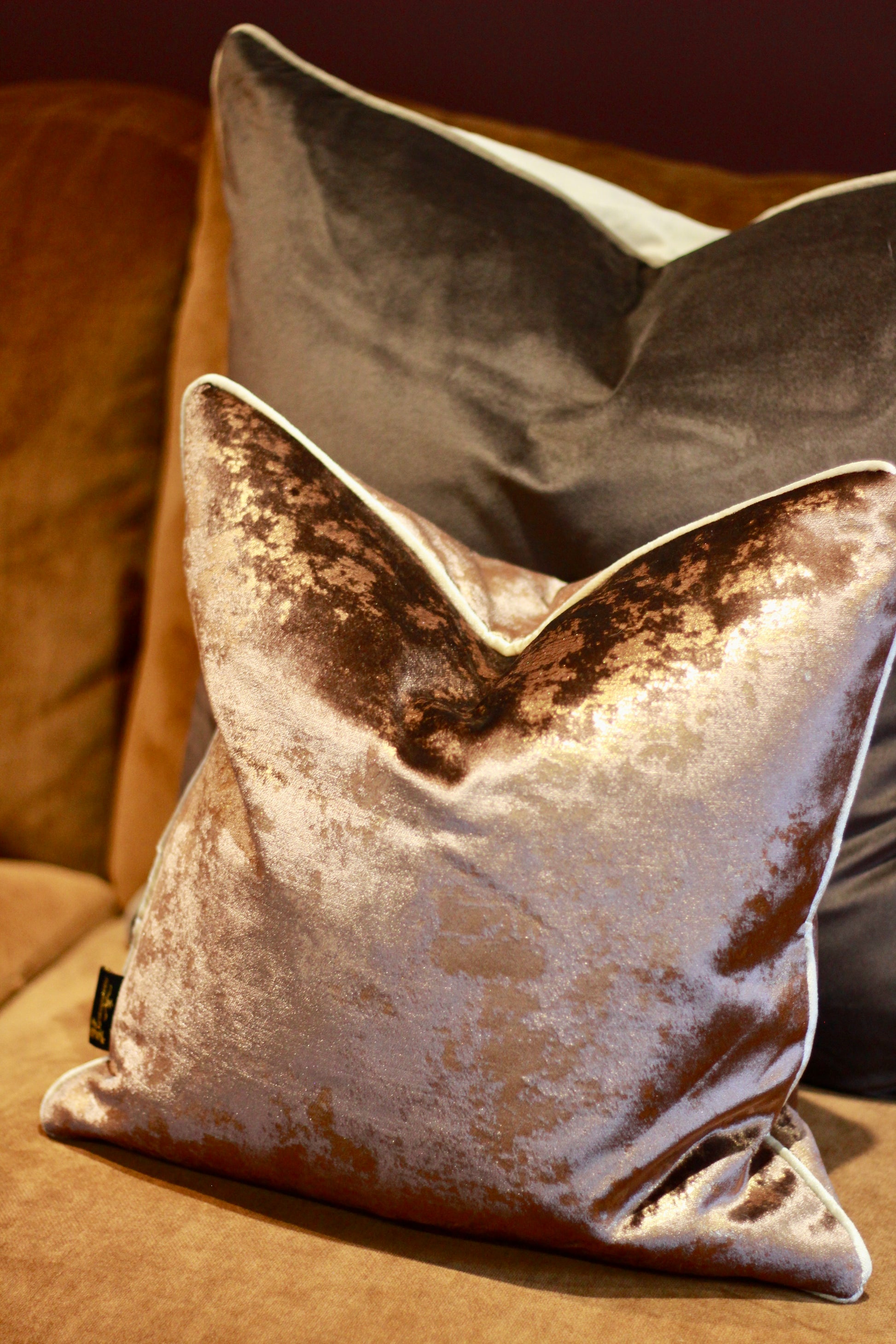 Chocolate cushion showing its bronze-toned metallic sheen in the light.