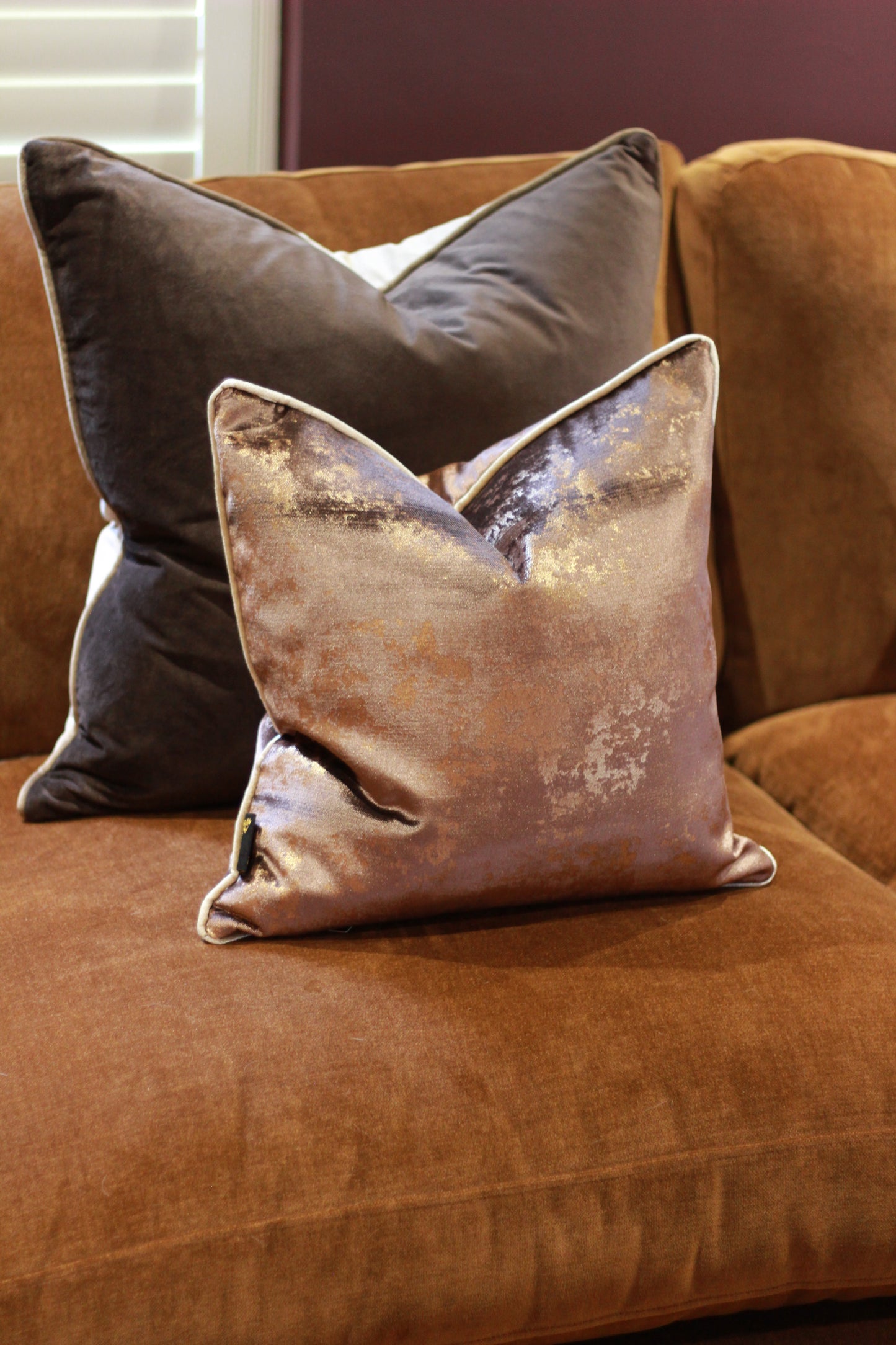 Close-up view of chocolate cushion with soft metallic shimmer.