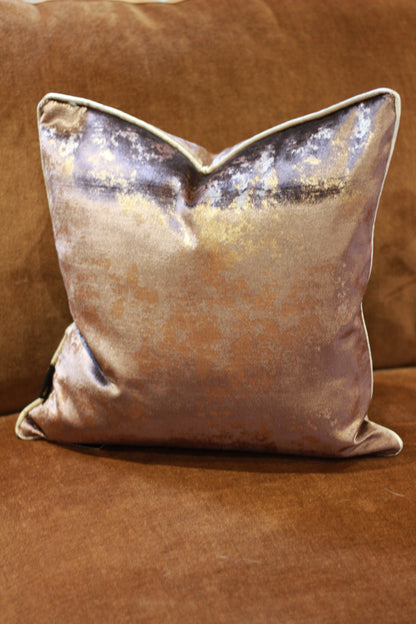 Chocolate velvet cushion showing elegant contrast piping around the edge.