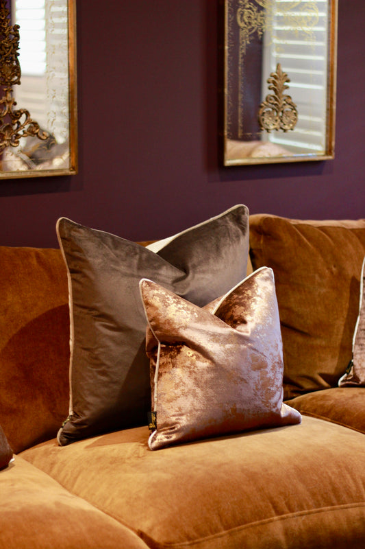 Chocolate metallic fleck velvet cushion with contrast piping and feather inner.
