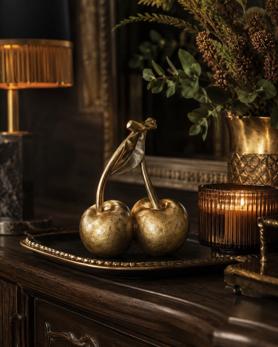 Gold cherry ornament displayed as a statement home accessory.