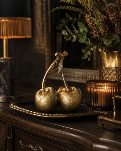 Gold cherry ornament displayed as a statement home accessory.