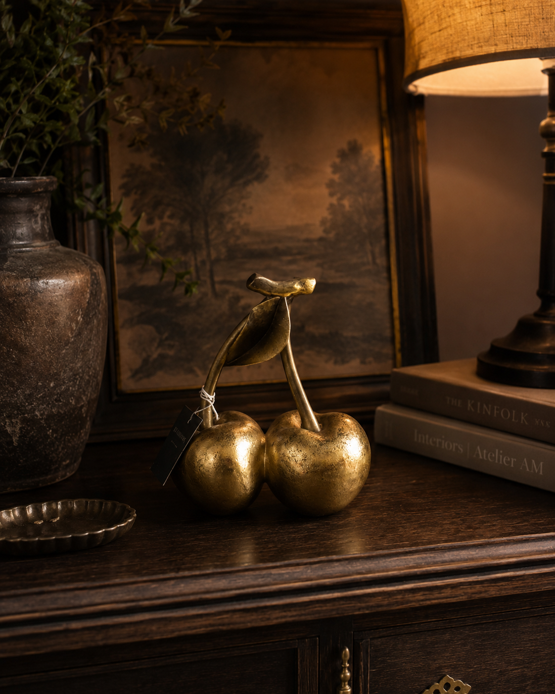 Decorative gold cherries styled with curated home accessories.