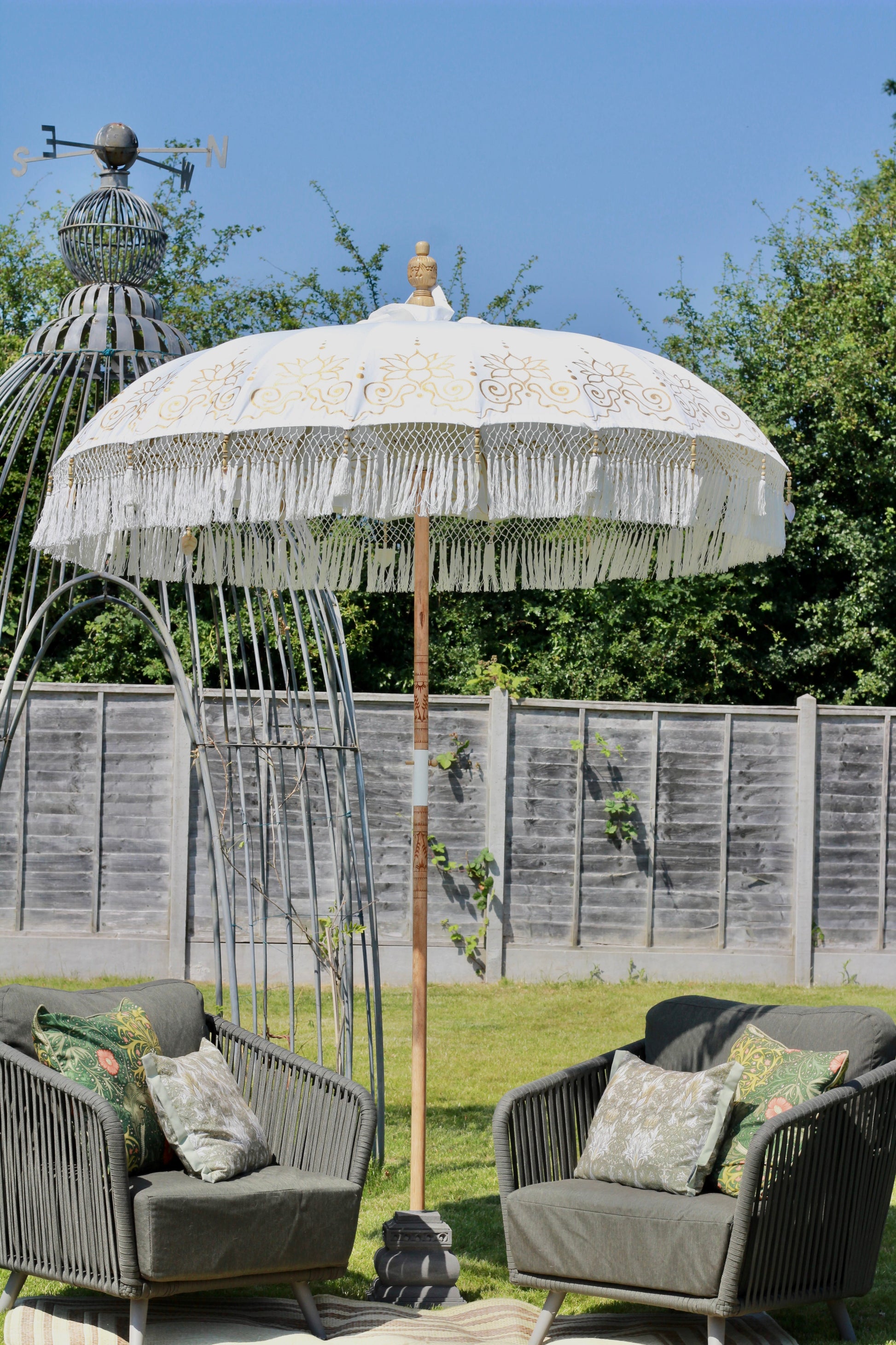 Decorative white and gold parasol with floral canopy detail for garden styling