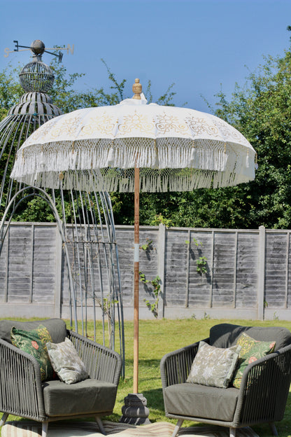 Decorative white and gold parasol with floral canopy detail for garden styling