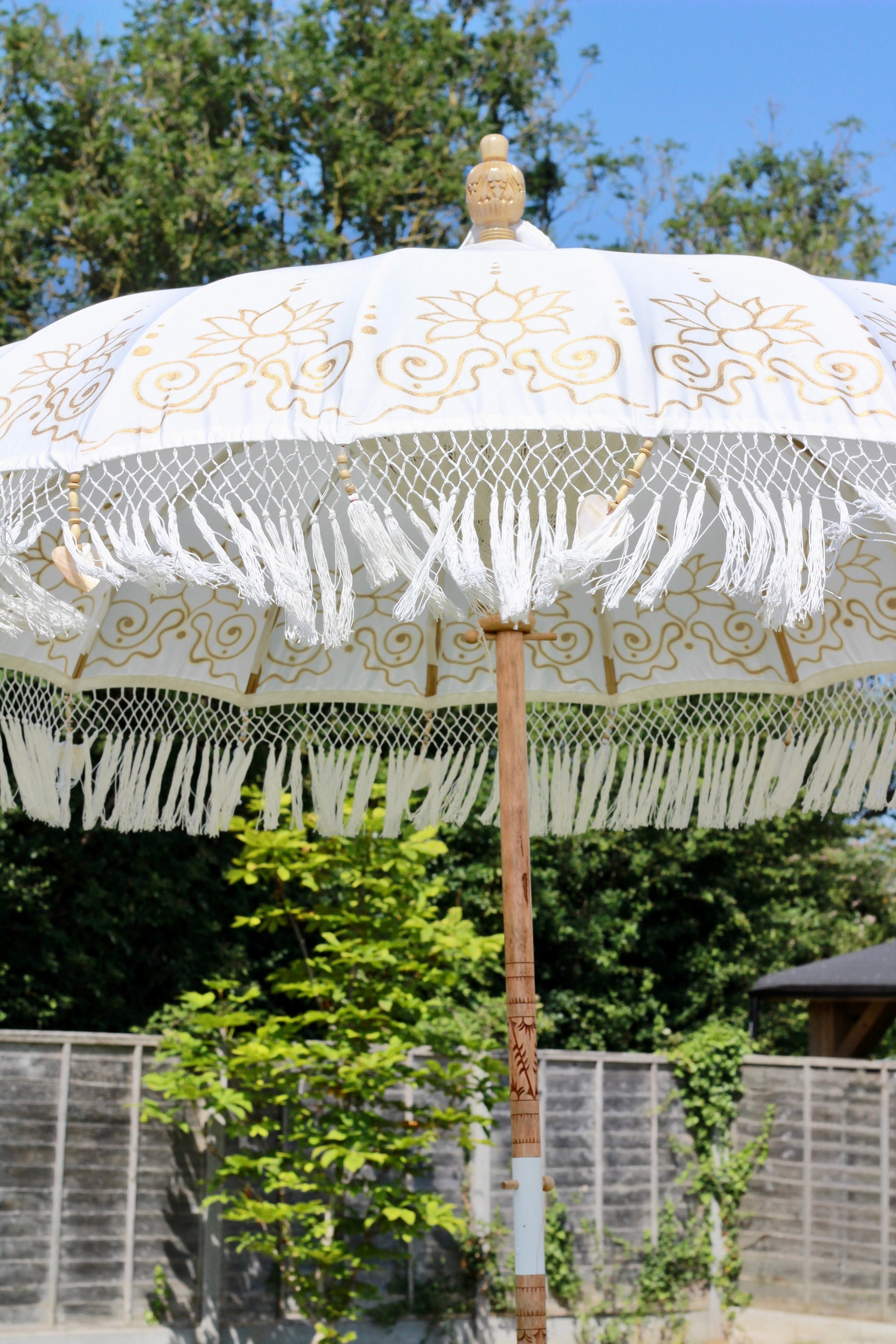 White and gold luxury garden parasol for decorative outdoor living and patio styling
