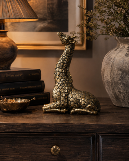 Gold giraffe ornament bringing playful animal character to a styled room.
