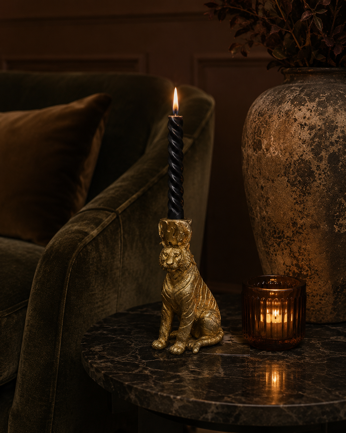 Close detail of the sculpted tiger candle holder in a gold finish.