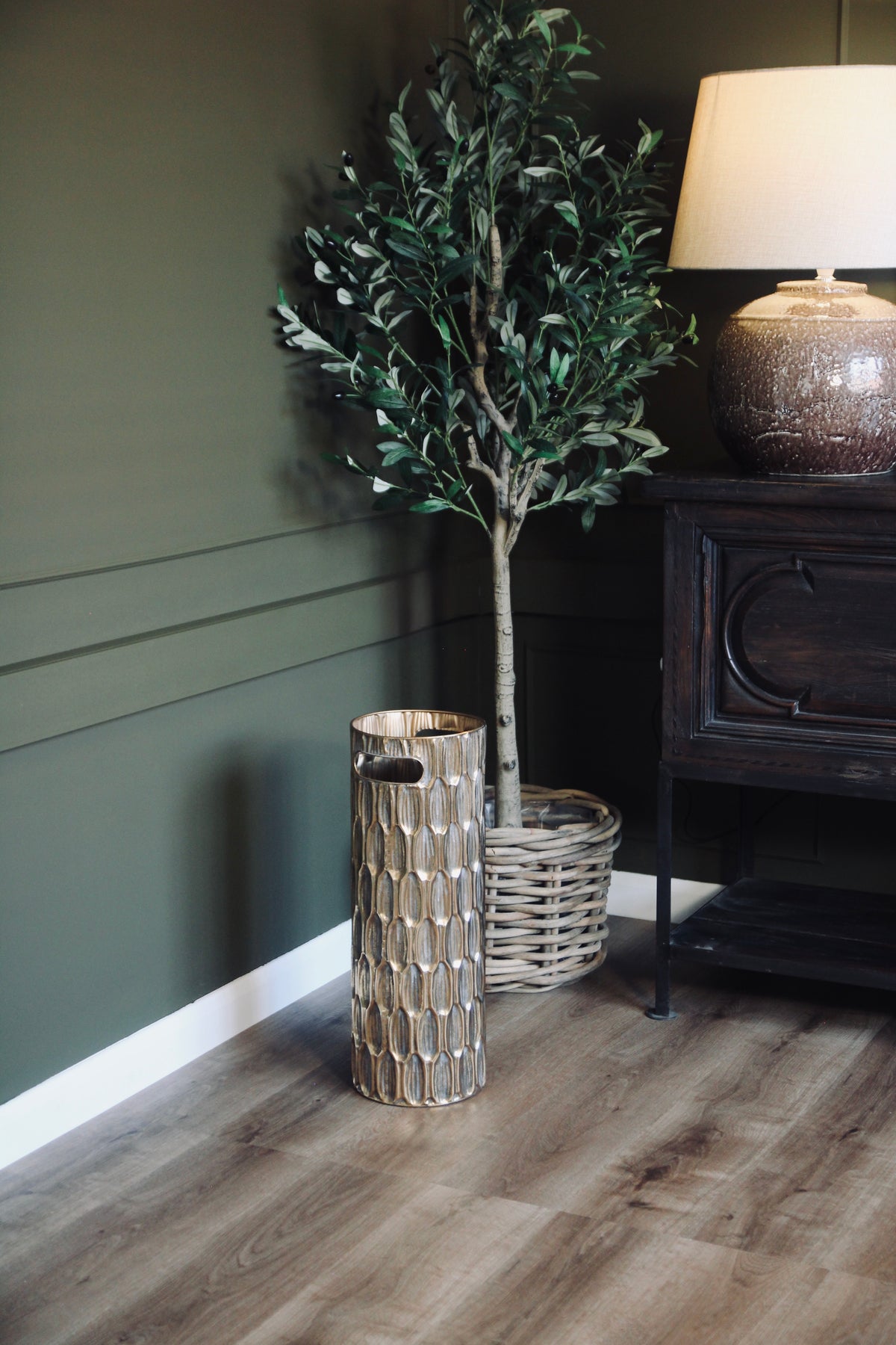 Detailed view of the textured gold finish on the decorative umbrella stand.