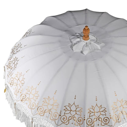 Top view of gold and white Balinese-style garden parasol showing hand painted floral border detail