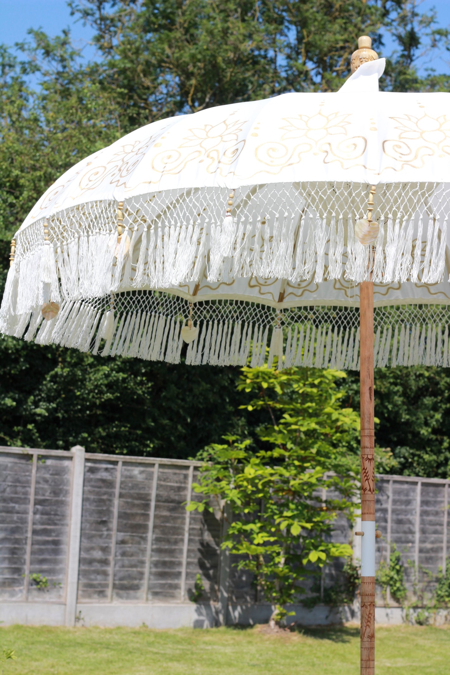 White and gold fringed garden parasol for elegant patio and terrace styling