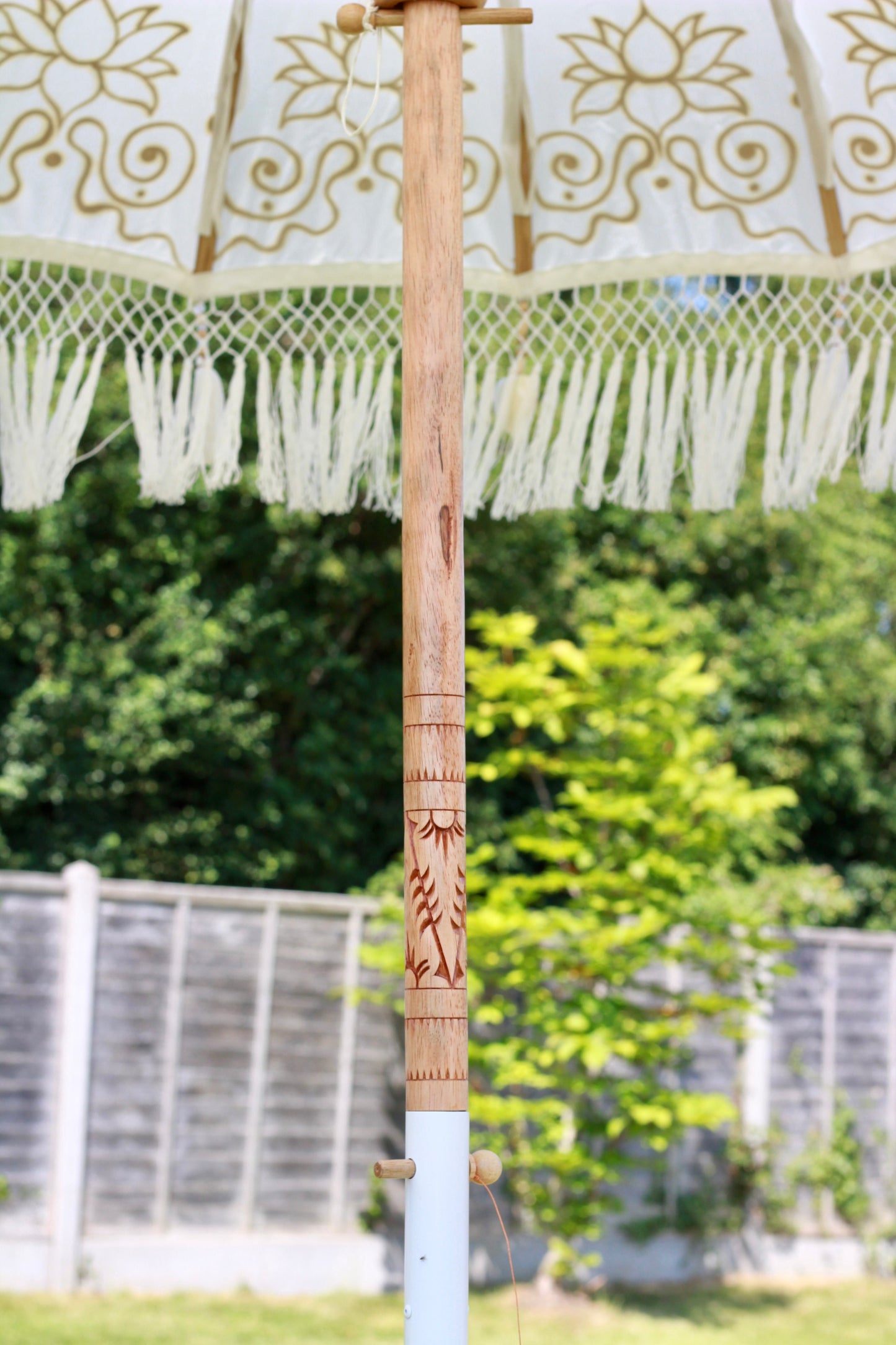 Hand painted gold and white Balinese-style garden parasol with decorative floral design