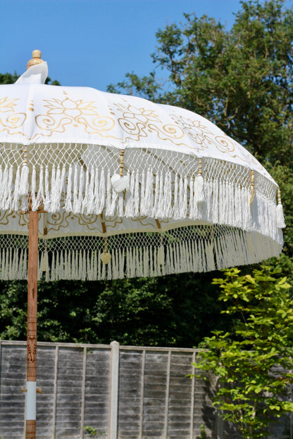 Handmade white and gold garden parasol as decorative outdoor decor for summer styling