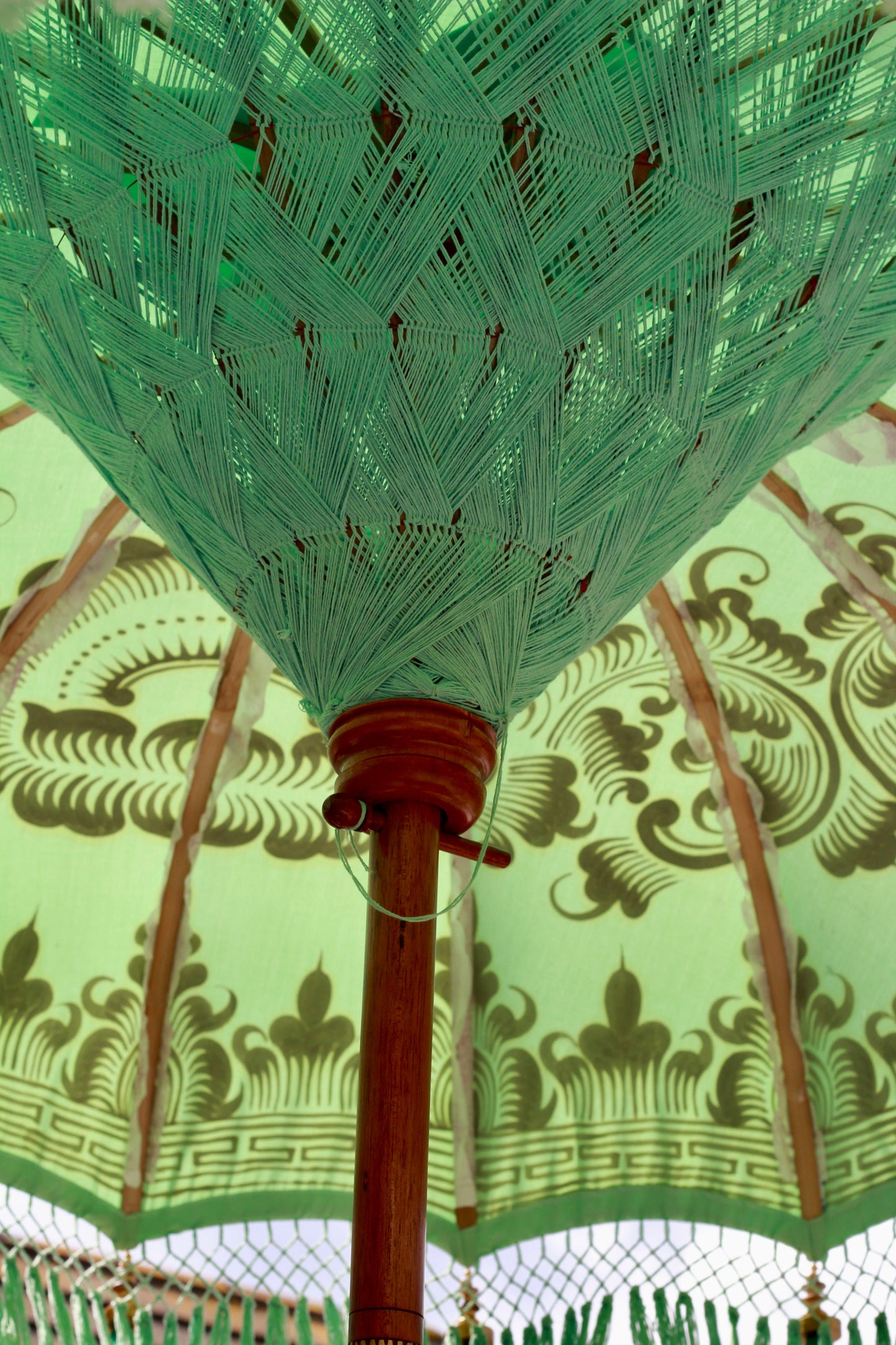 Riviera Mint handmade Balinese-style garden parasol styled in an English garden setting