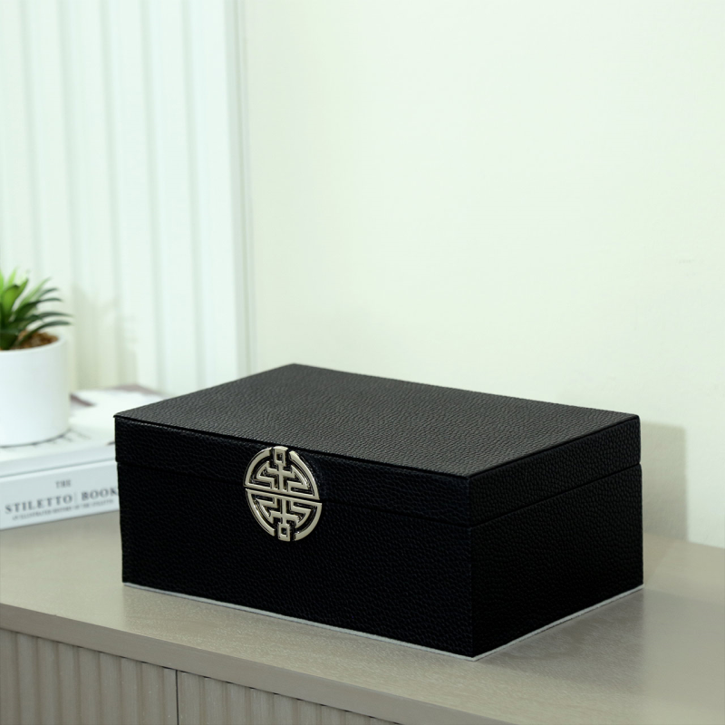 Luxury black jewellery box with silver emblem and grey velvet interior