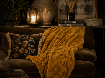 Whiskey faux rabbit fur throw draped over seating, showing its soft textured ruffles.