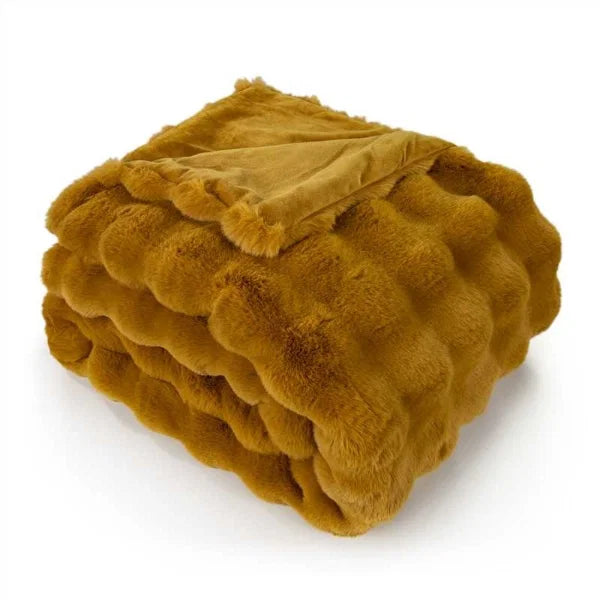 Close-up of soft whiskey brown faux rabbit fur throw with textured ruffle detail.