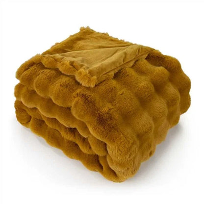 Close-up of soft whiskey brown faux rabbit fur throw with textured ruffle detail.