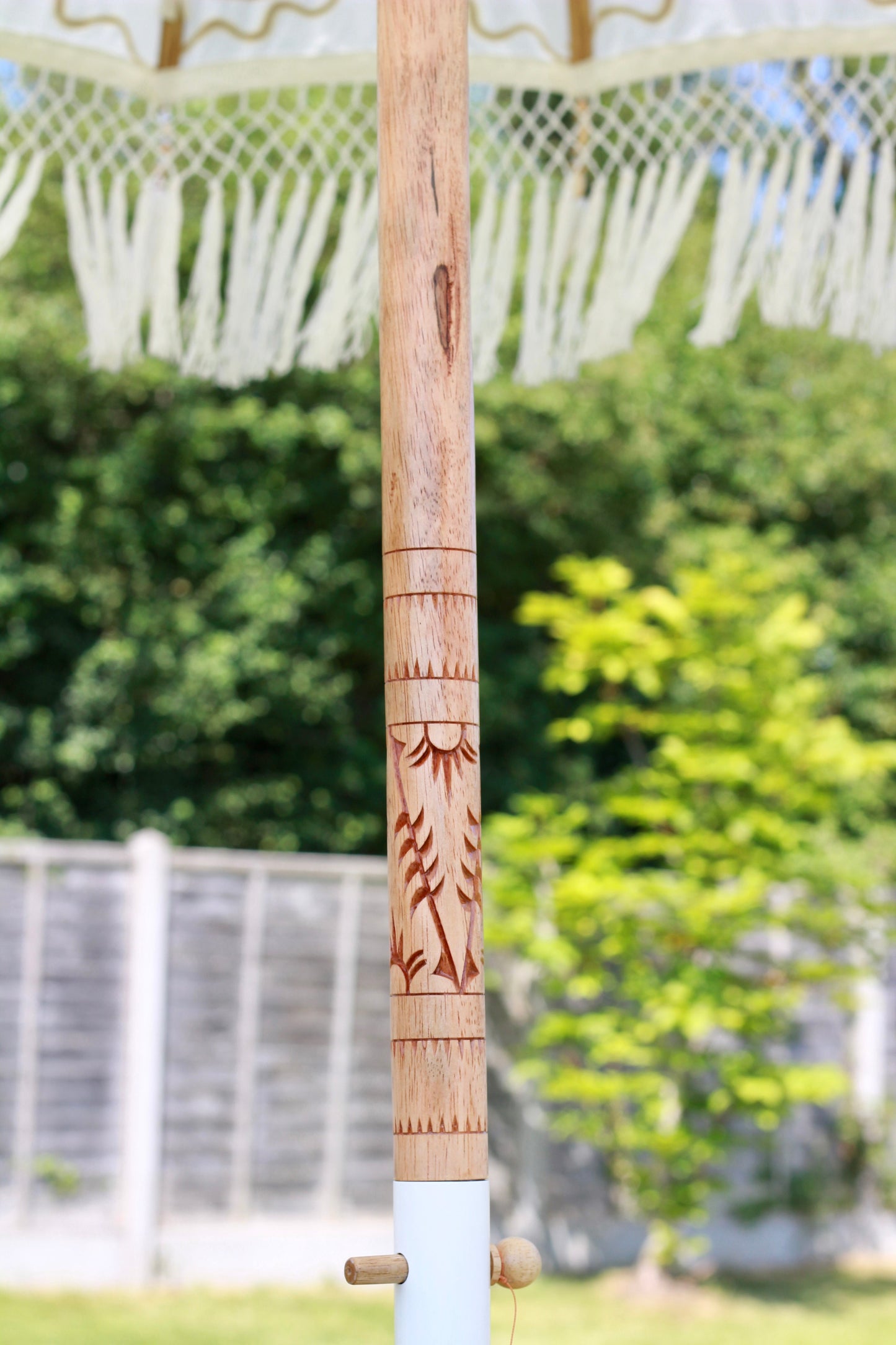 White and gold garden parasol with decorative fringe for summer patio styling